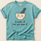Teal t-shirt with mortar and pestle graphic and "Crush it like you mean it" text.