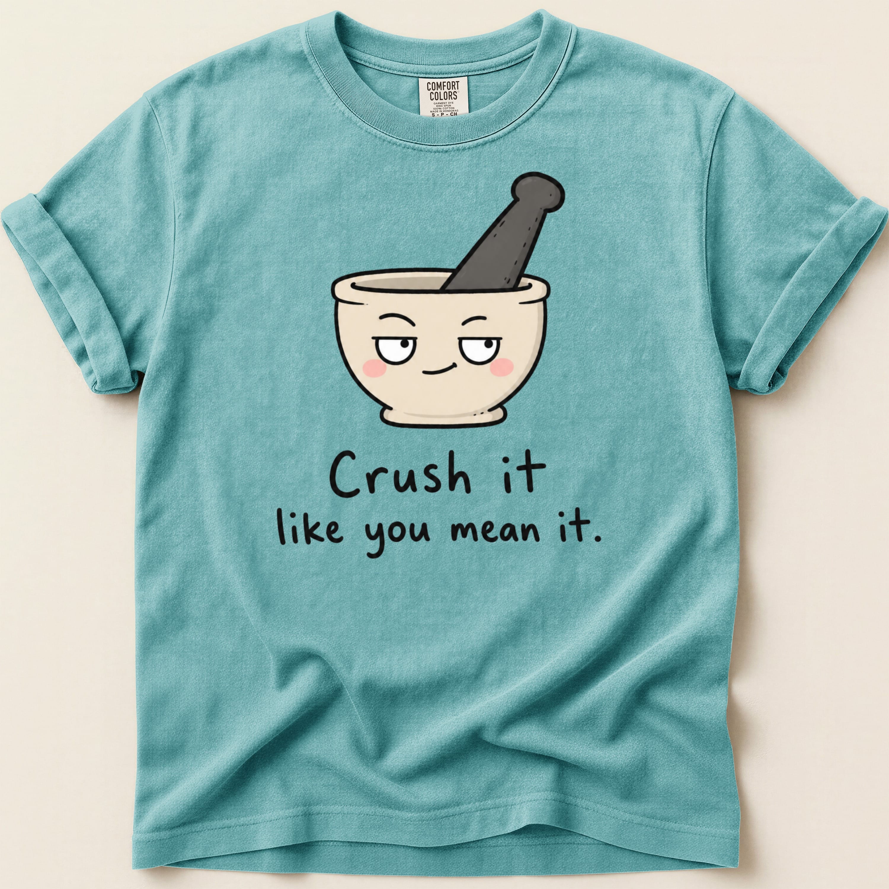 Teal t-shirt with mortar and pestle graphic and "Crush it like you mean it" text.