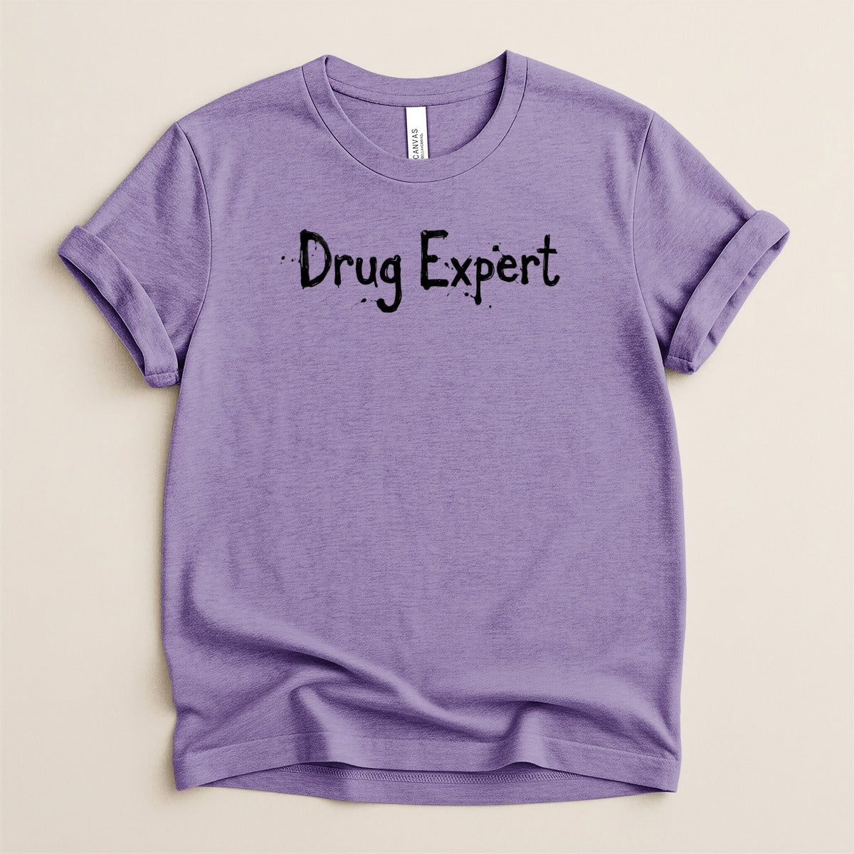 Purple t-shirt with "Drug Expert" text in black, distressed lettering.