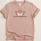 Pink t-shirt with a cartoon crab wearing glasses and a lab coat.