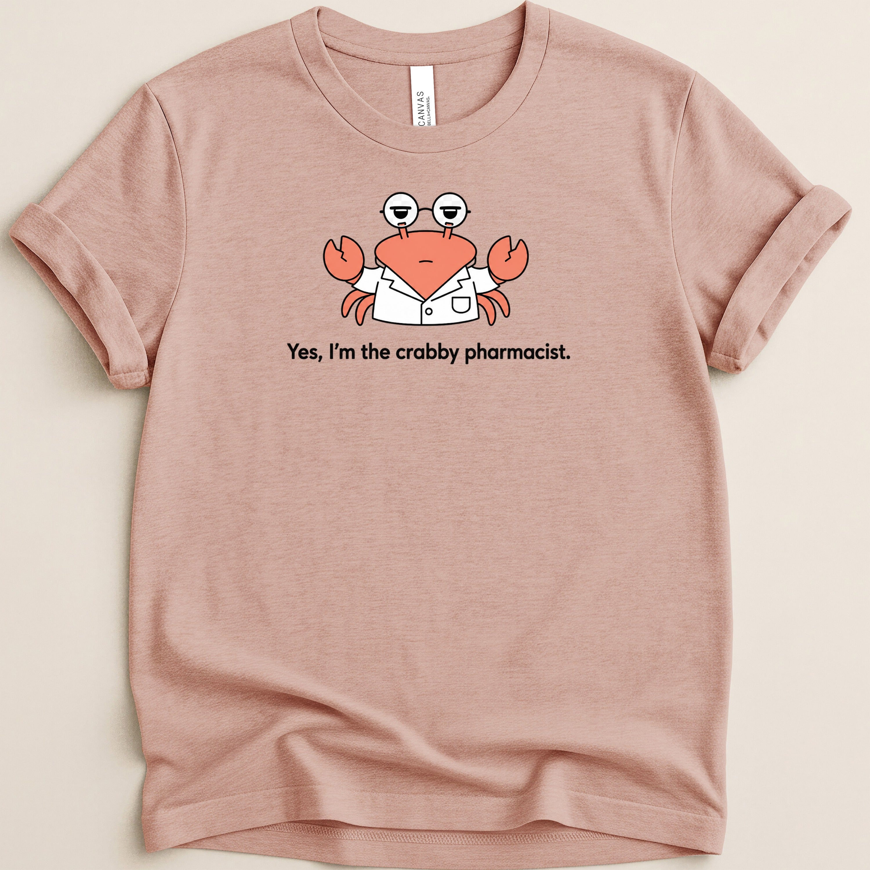 Pink t-shirt with a cartoon crab wearing glasses and a lab coat.