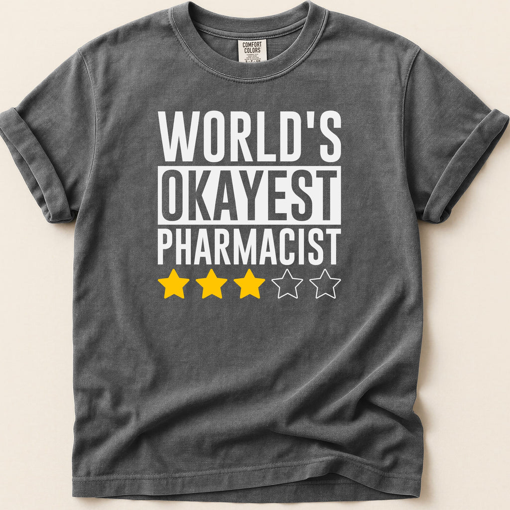 T-shirt with "World's Okayest Pharmacist" text and three yellow stars.