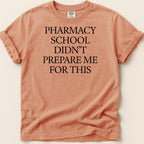 Orange t-shirt with "Pharmacy school didn't prepare me for this" in black text.