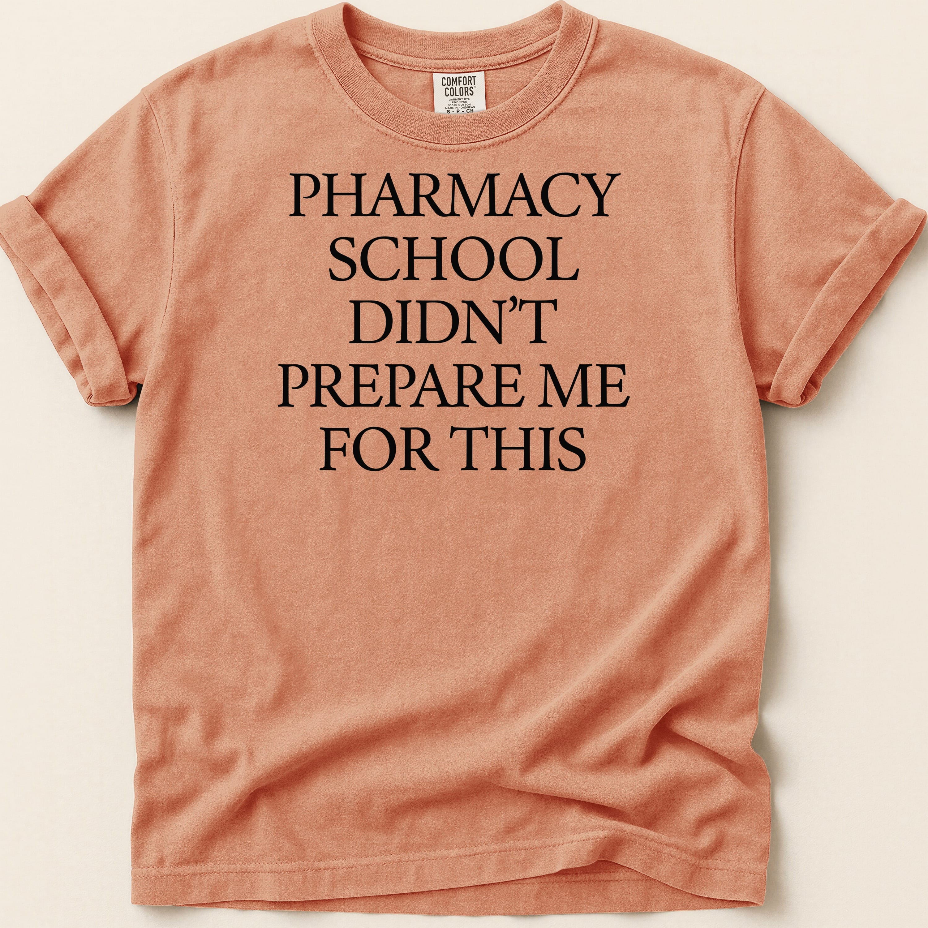 Orange t-shirt with "Pharmacy school didn't prepare me for this" in black text.