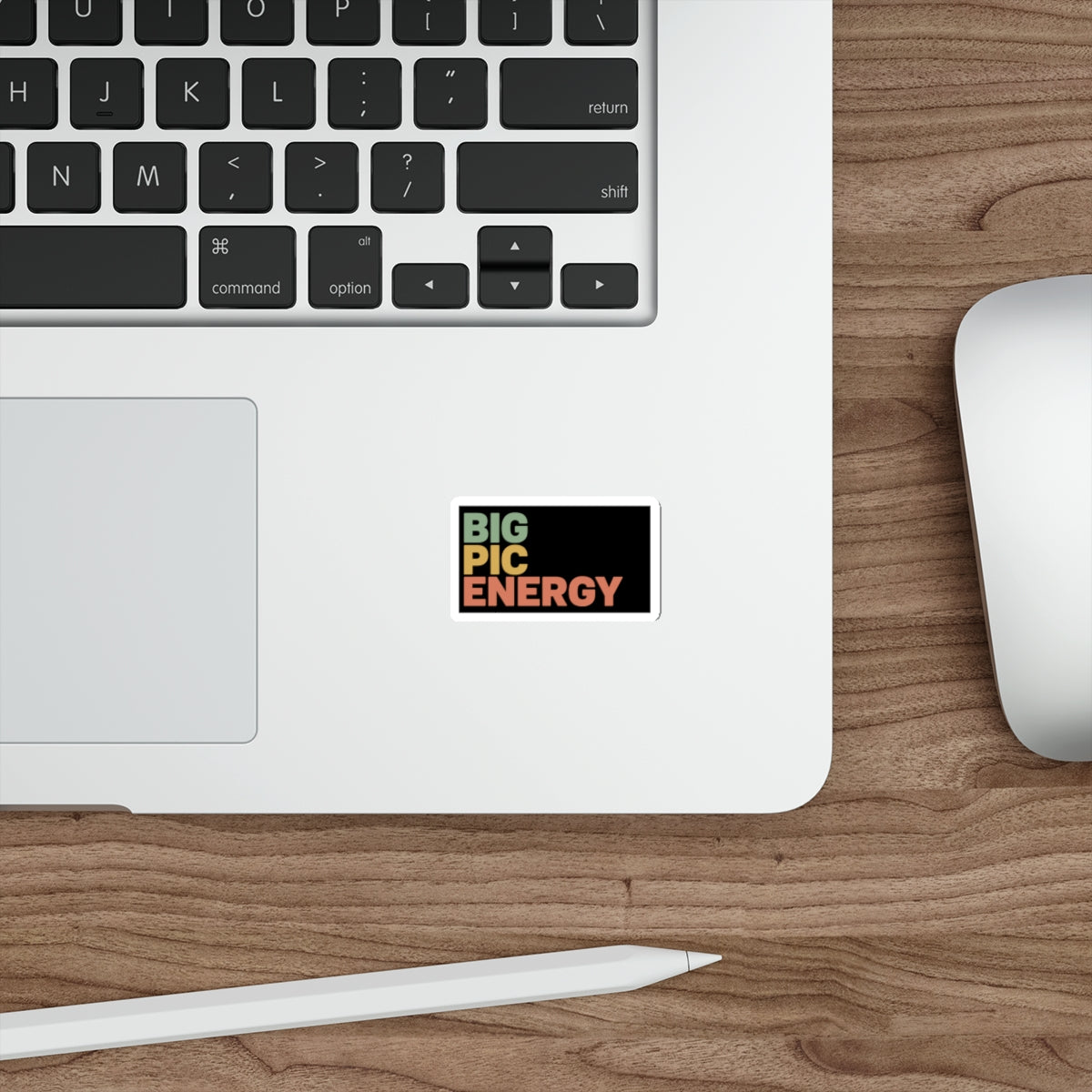 Sticker with "BIG PIC ENERGY" text on a laptop keyboard.