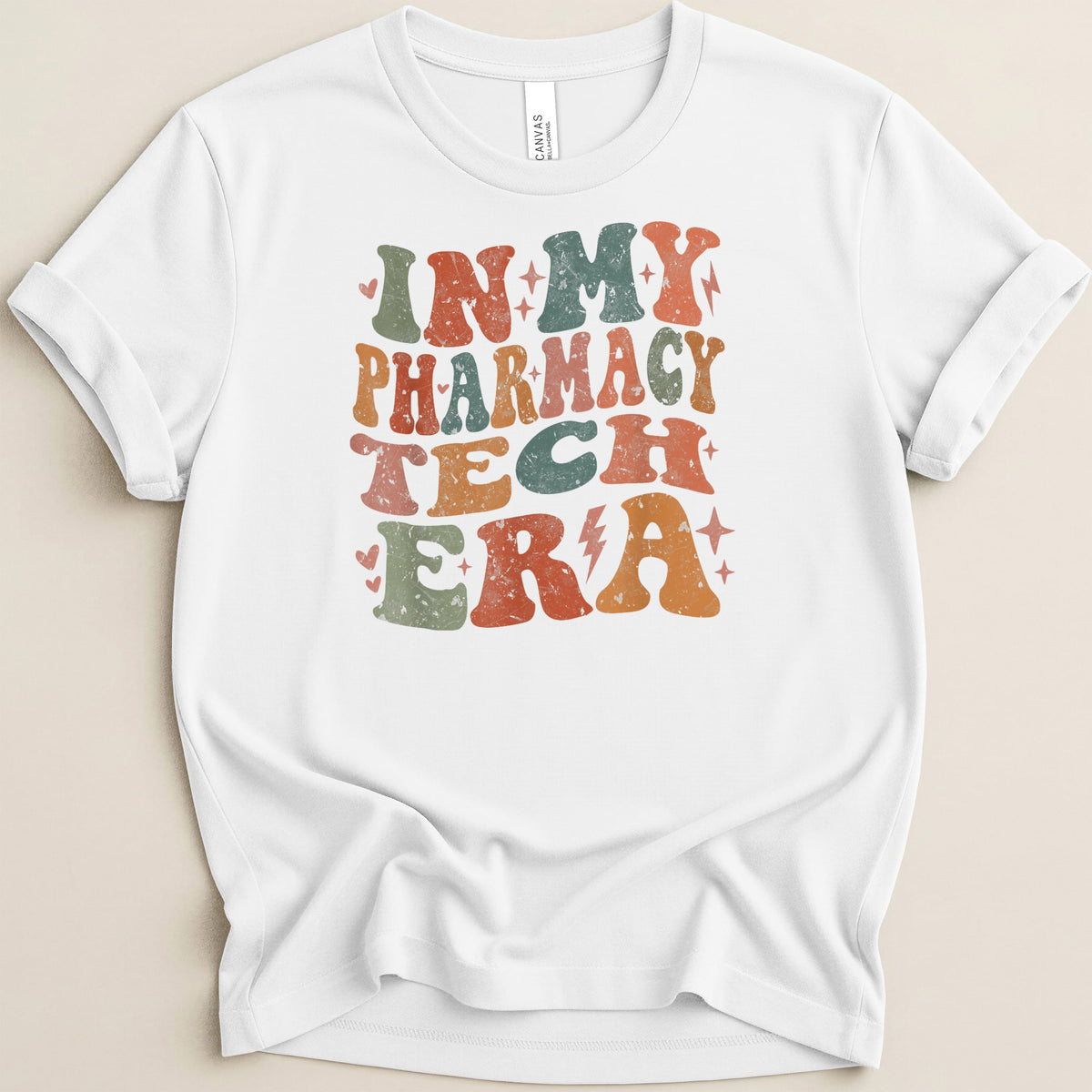 White t-shirt with "In My Pharmacy Tech Era" in distressed retro font.