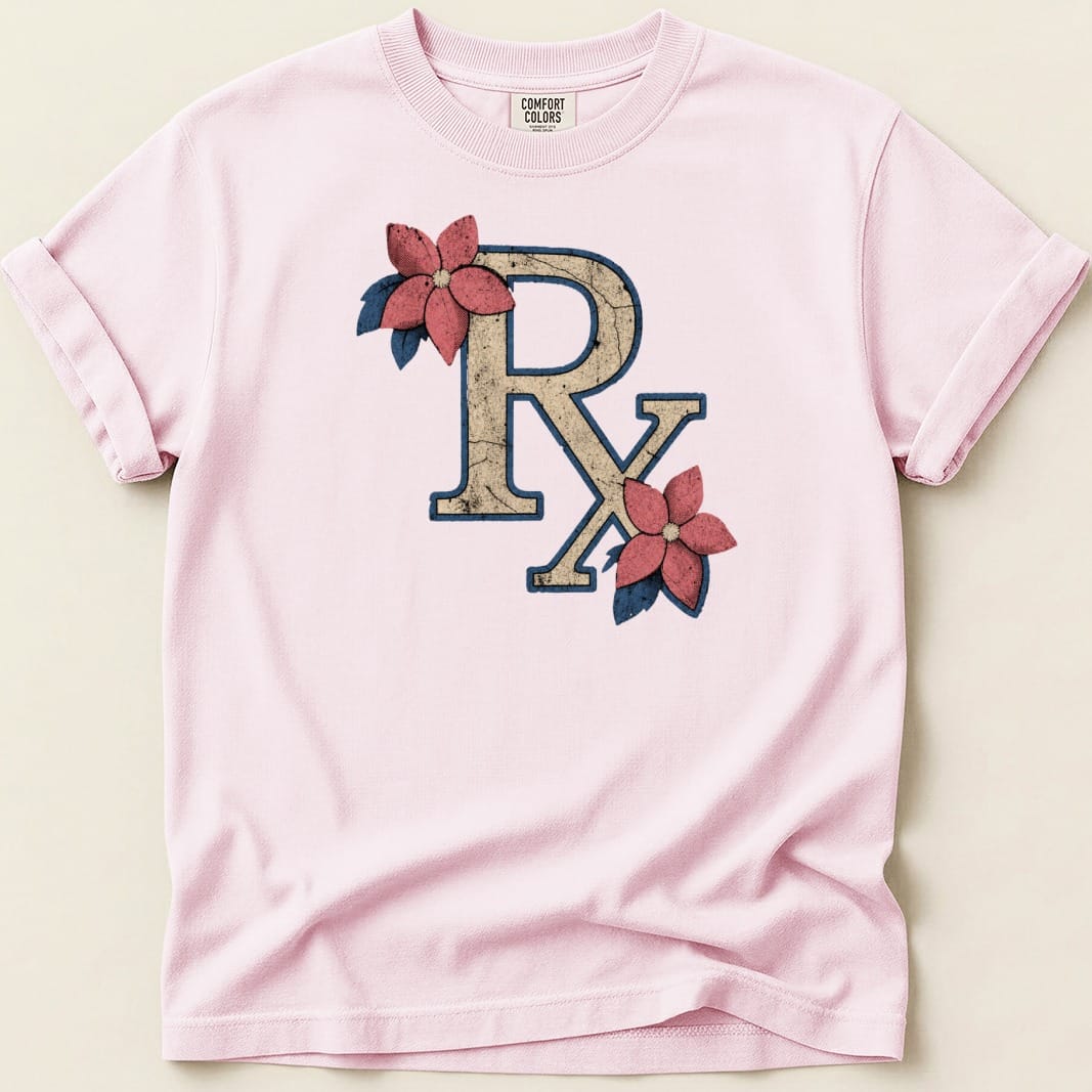 Pink t-shirt with distressed Rx symbol featuring two floral accents.