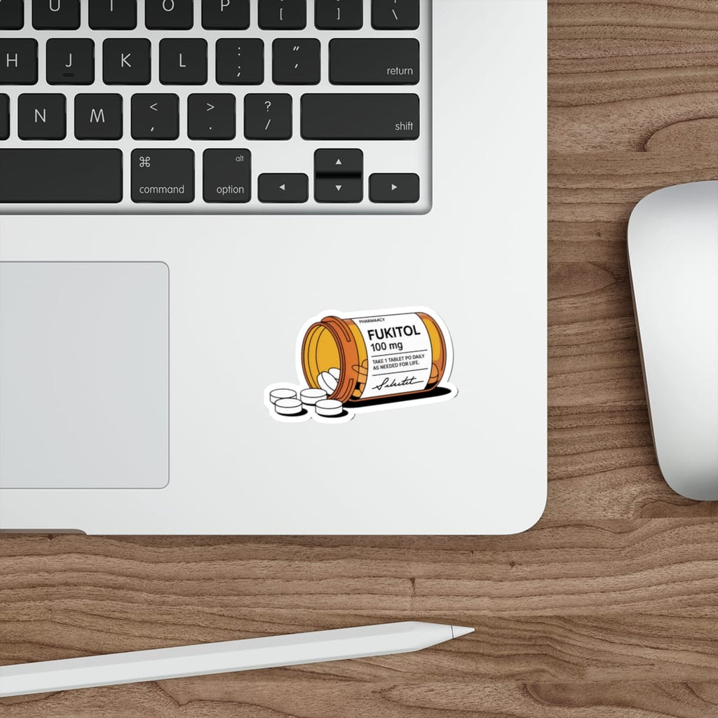 Pill bottle labeled FUKITOL 100 mg on a laptop with scattered pills.