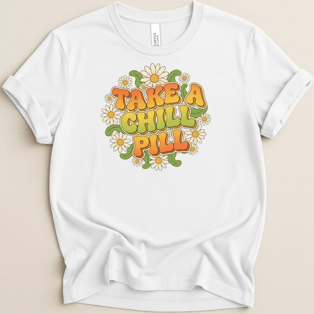 White t-shirt with "TAKE A CHILL PILL" text surrounded by daisies.