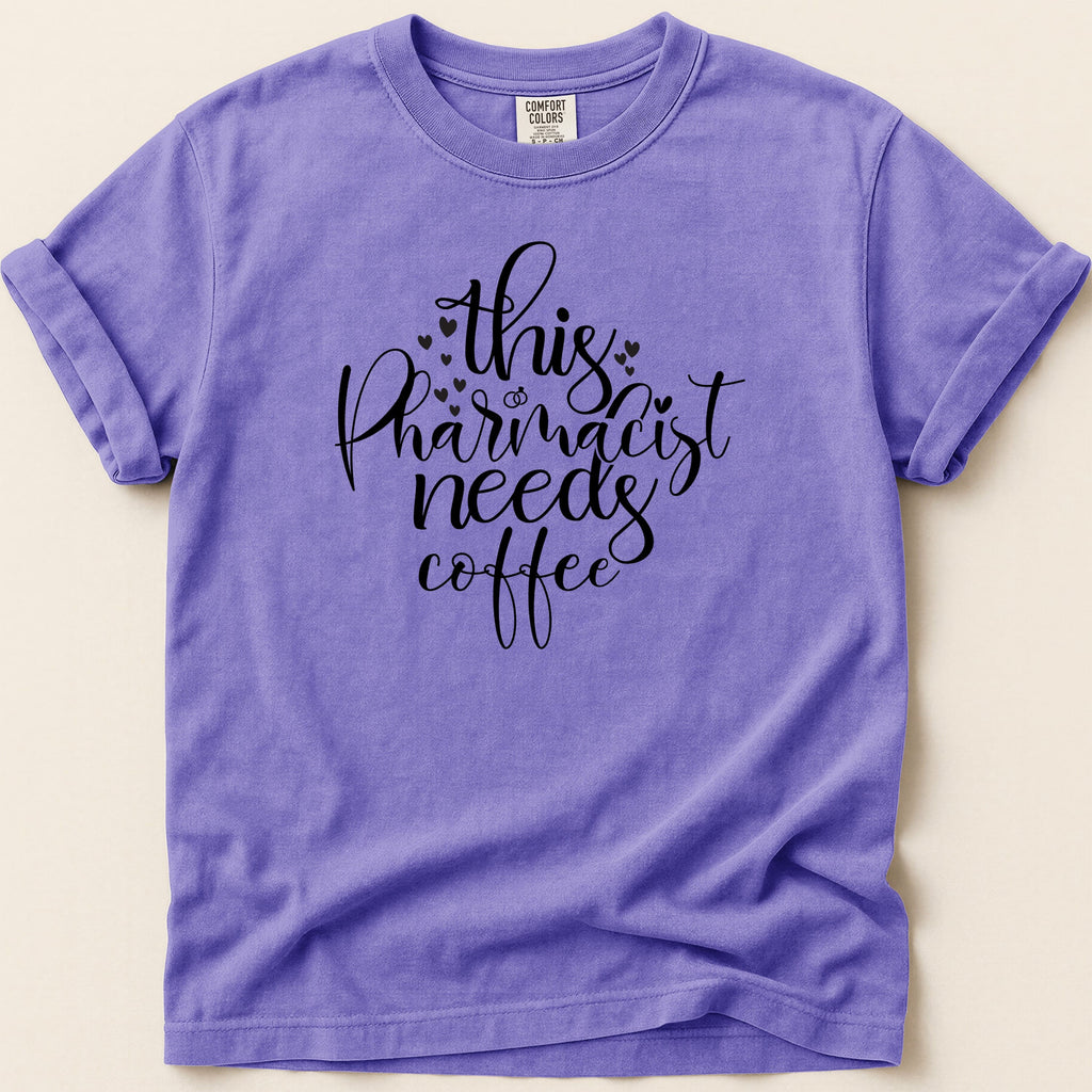 Purple t-shirt with "This Pharmacist Needs Coffee" text design.
