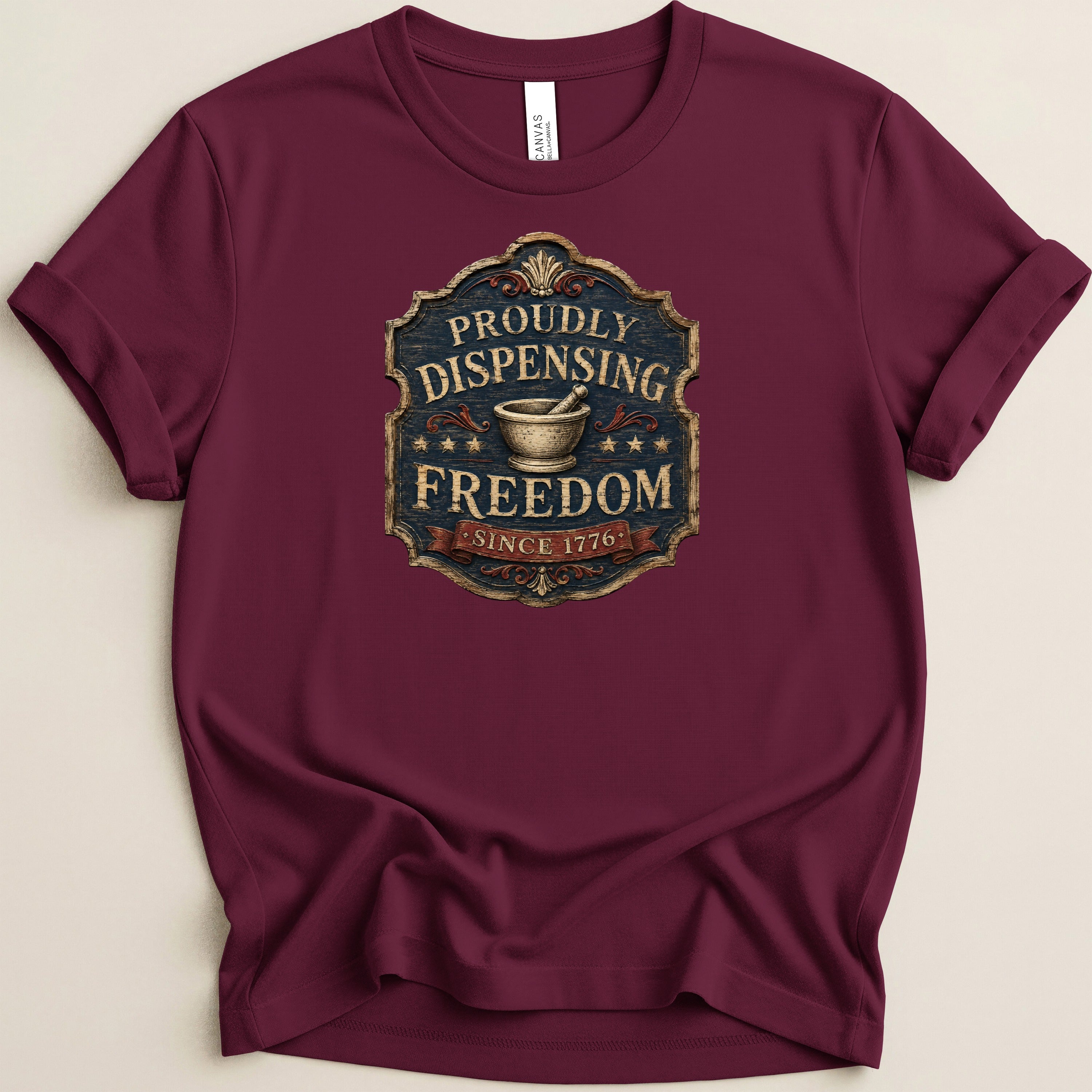 Maroon t-shirt with a "Proudly Dispensing Freedom Since 1776" emblem.