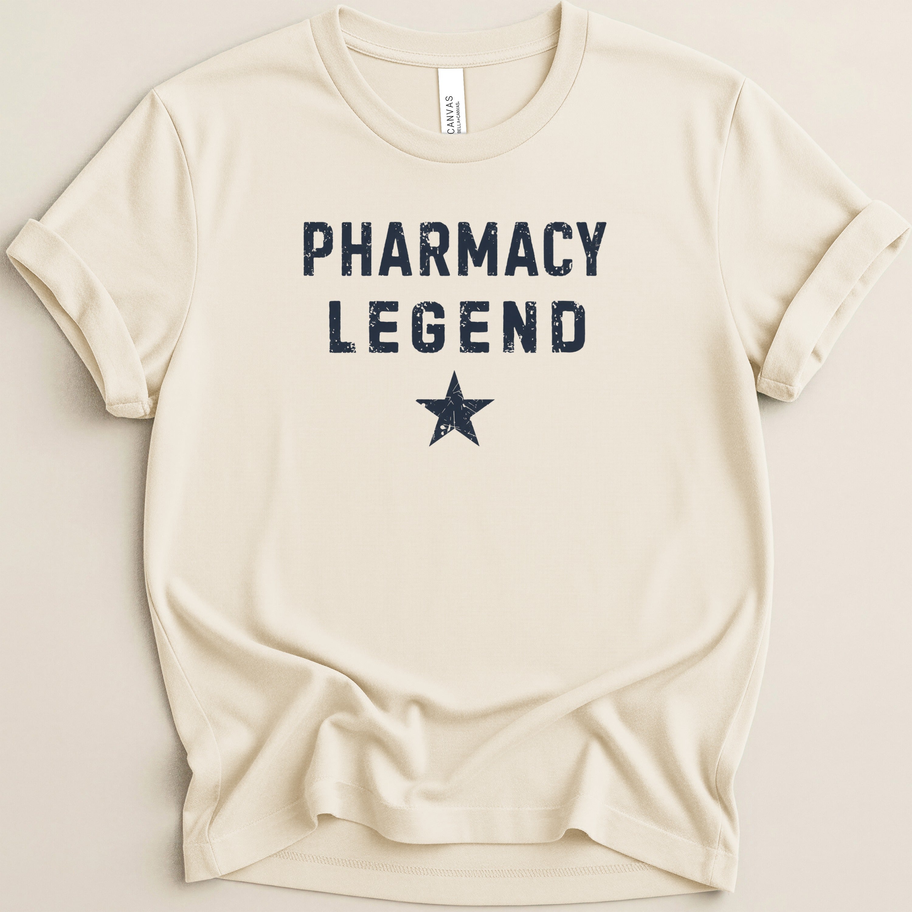 Cream t-shirt with "PHARMACY LEGEND" and a star in distressed navy blue.