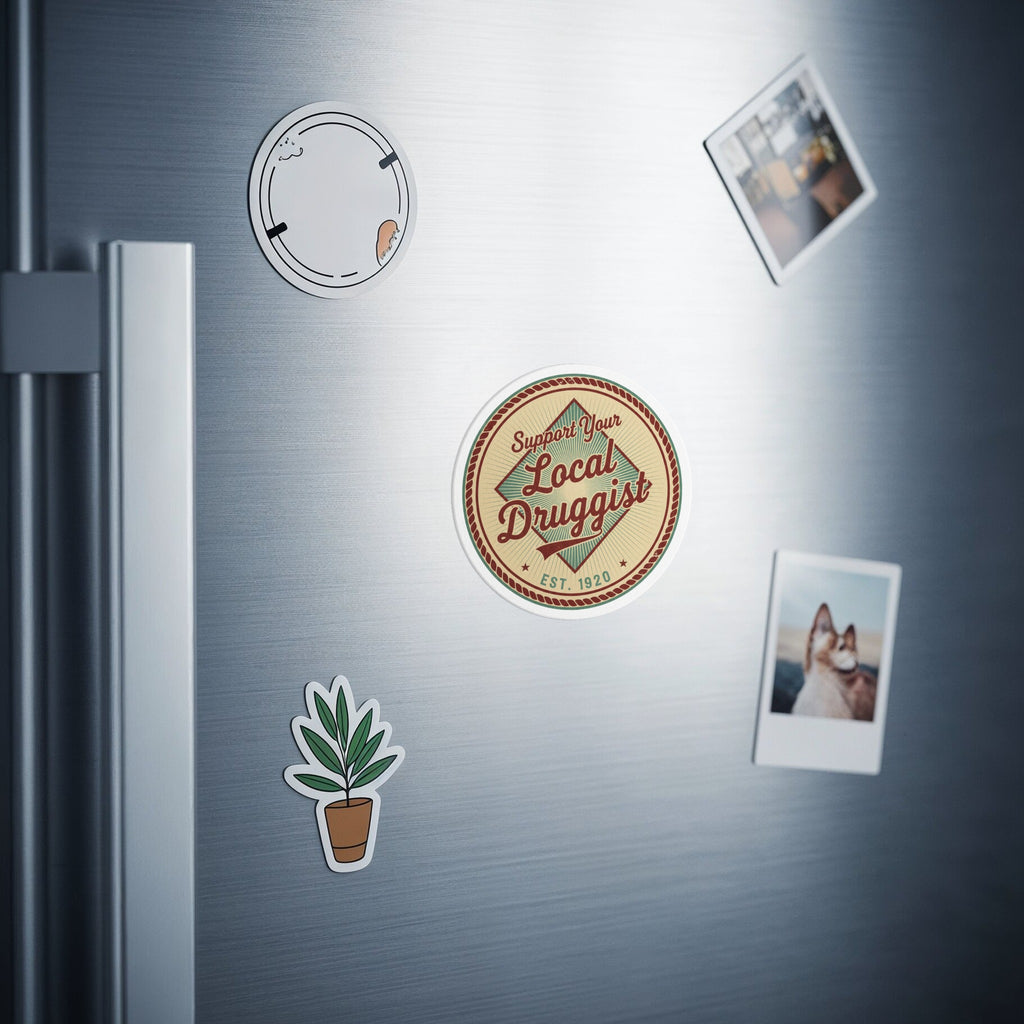Round sticker with "Support Your Local Druggist" and a small plant sticker on a refrigerator.