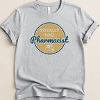 Gray t-shirt with "TOTALLY RAD Pharmacist" text and pill graphic.