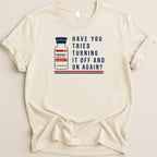 Cream t-shirt with image of Adenosine injection vial and text "Have You Tried Turning It Off and On Again?".