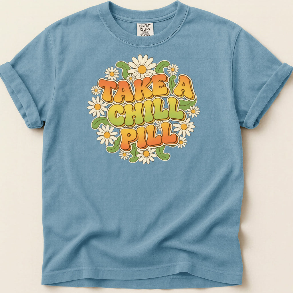 Blue t-shirt with "Take a Chill Pill" text surrounded by flowers.