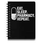 Black spiral notebook with "Eat. Sleep. Pharmacy. Repeat." text and pill graphic.