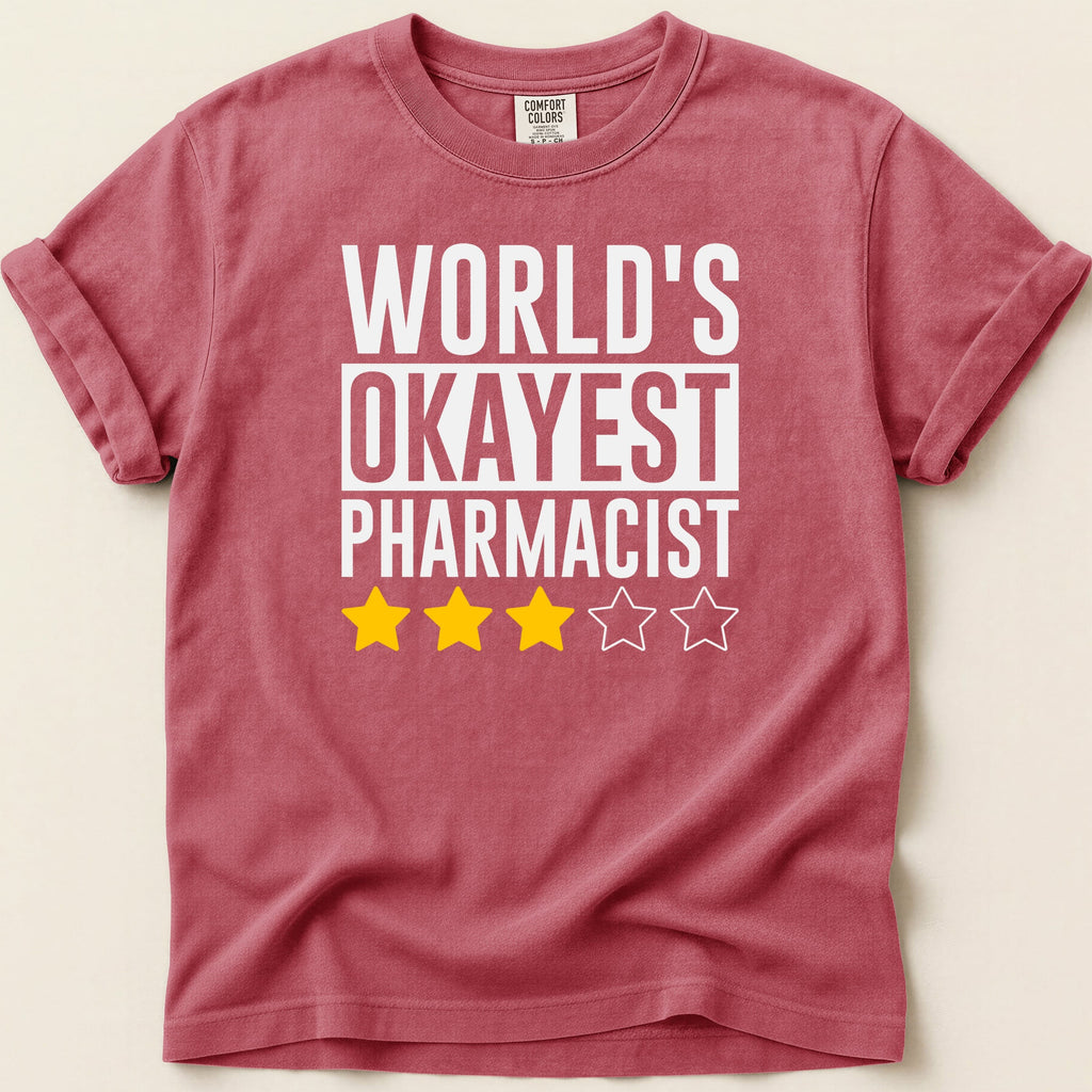 T-shirt with "World's Okayest Pharmacist" text and three yellow stars.