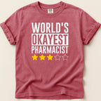 T-shirt with "World's Okayest Pharmacist" text and three yellow stars.