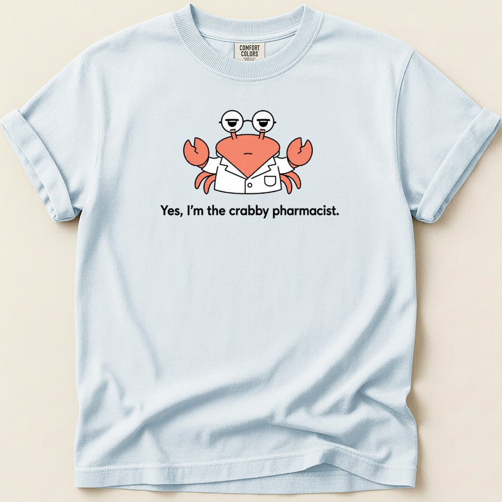 Light blue t-shirt features a cartoon crab in a lab coat with glasses and text 'Yes, I'm the crabby pharmacist.'