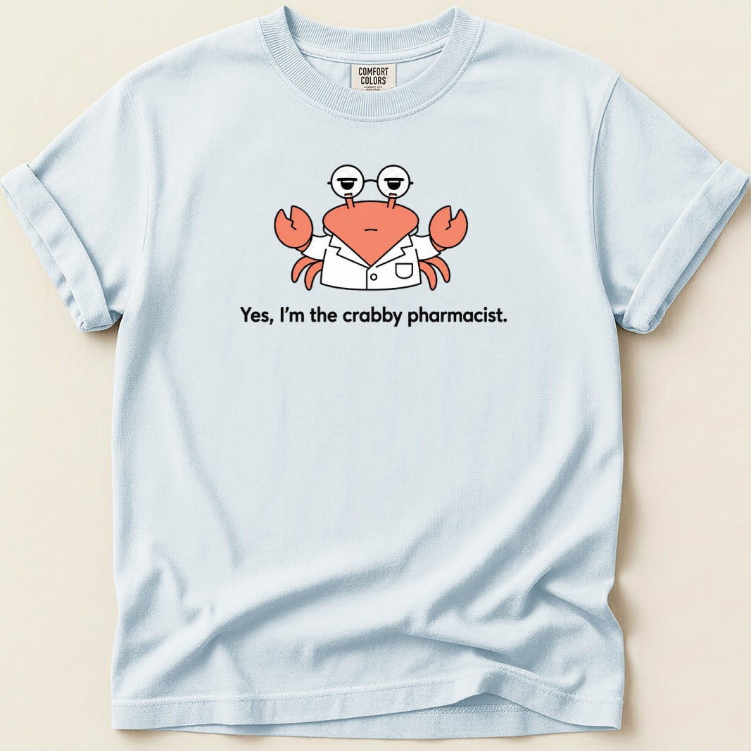 Light blue t-shirt features a cartoon crab in a lab coat with glasses and text 'Yes, I'm the crabby pharmacist.'