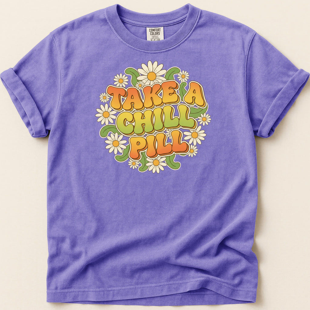 Purple t-shirt with "Take a Chill Pill" text and flower graphic.
