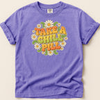 Purple t-shirt with "Take a Chill Pill" text and flower graphic.