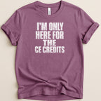 Purple t-shirt with "I'M ONLY HERE FOR THE CE CREDITS" printed in white text.