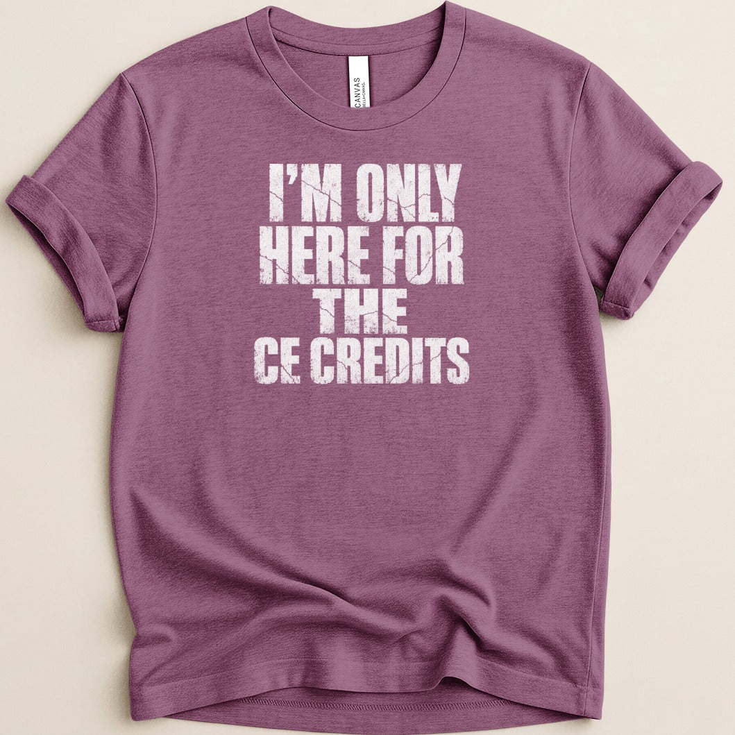 Purple t-shirt with "I'M ONLY HERE FOR THE CE CREDITS" printed in white text.