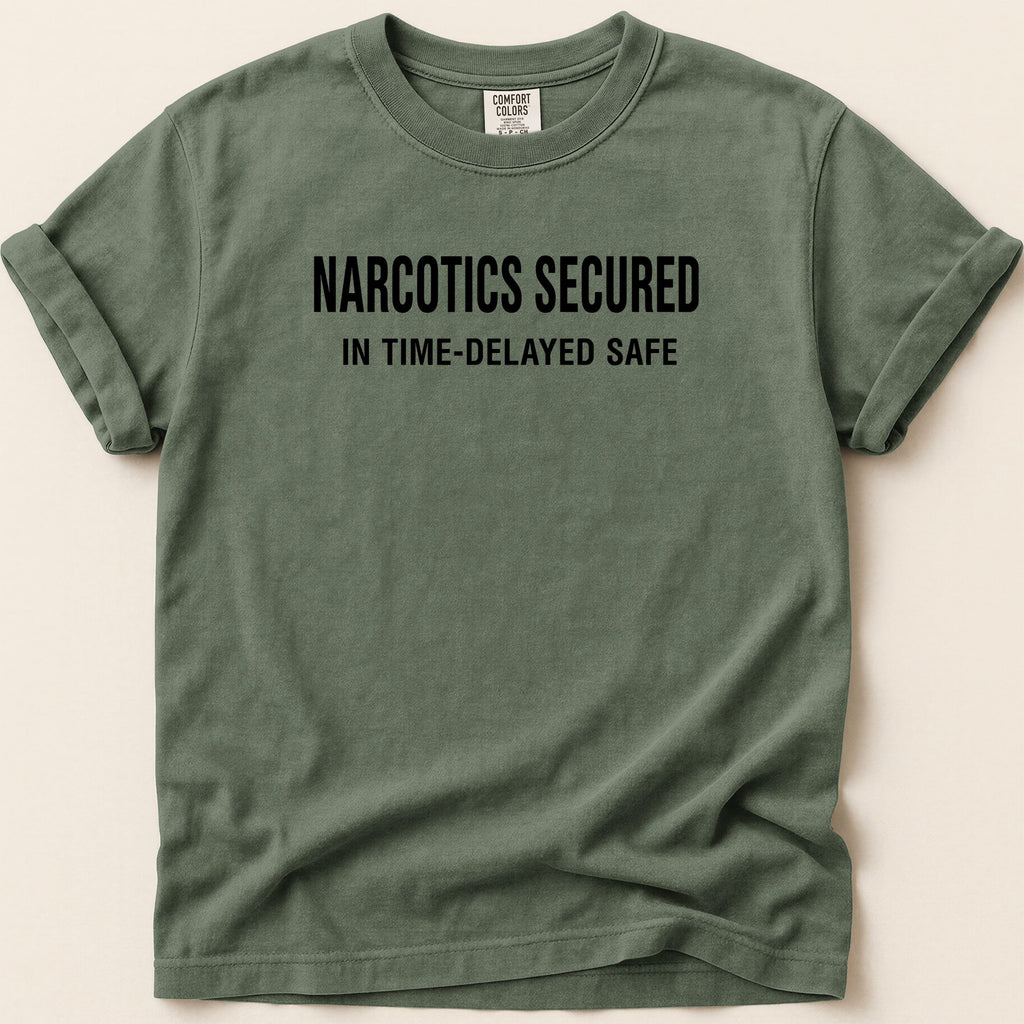Green t-shirt with "NARCOTICS SECURED IN TIME-DELAYED SAFE" text.