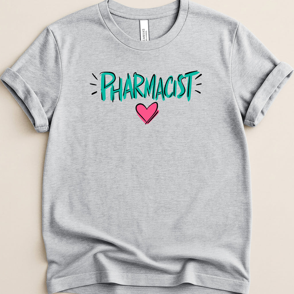 Grey t-shirt with "PHARMACIST" in turquoise and a pink heart.