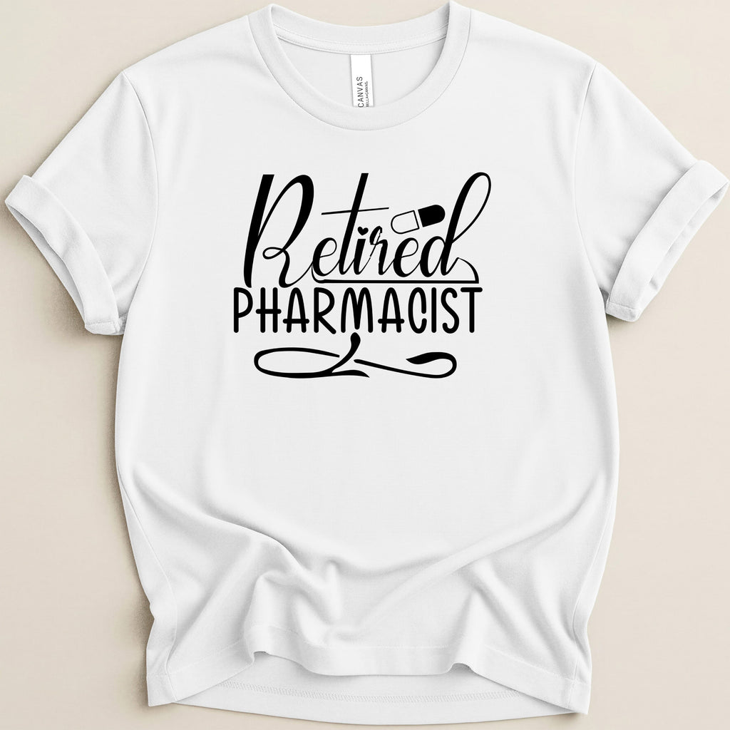 White t-shirt with black text that says "Retired Pharmacist" and a pill icon.