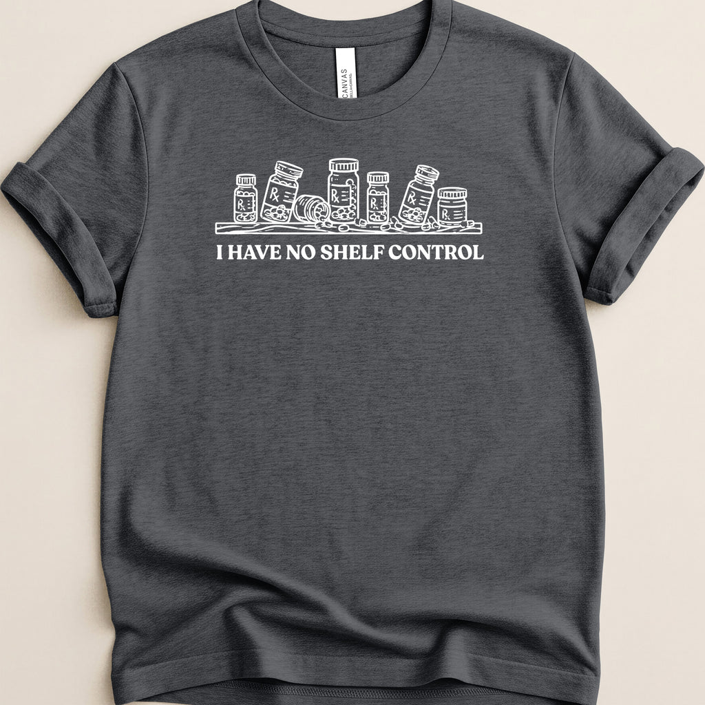 Dark gray t-shirt with white line art of prescription bottles and text "I HAVE NO SHELF CONTROL".