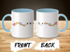 White mug with light blue handle and rim, featuring cartoon pills and smiley faces.