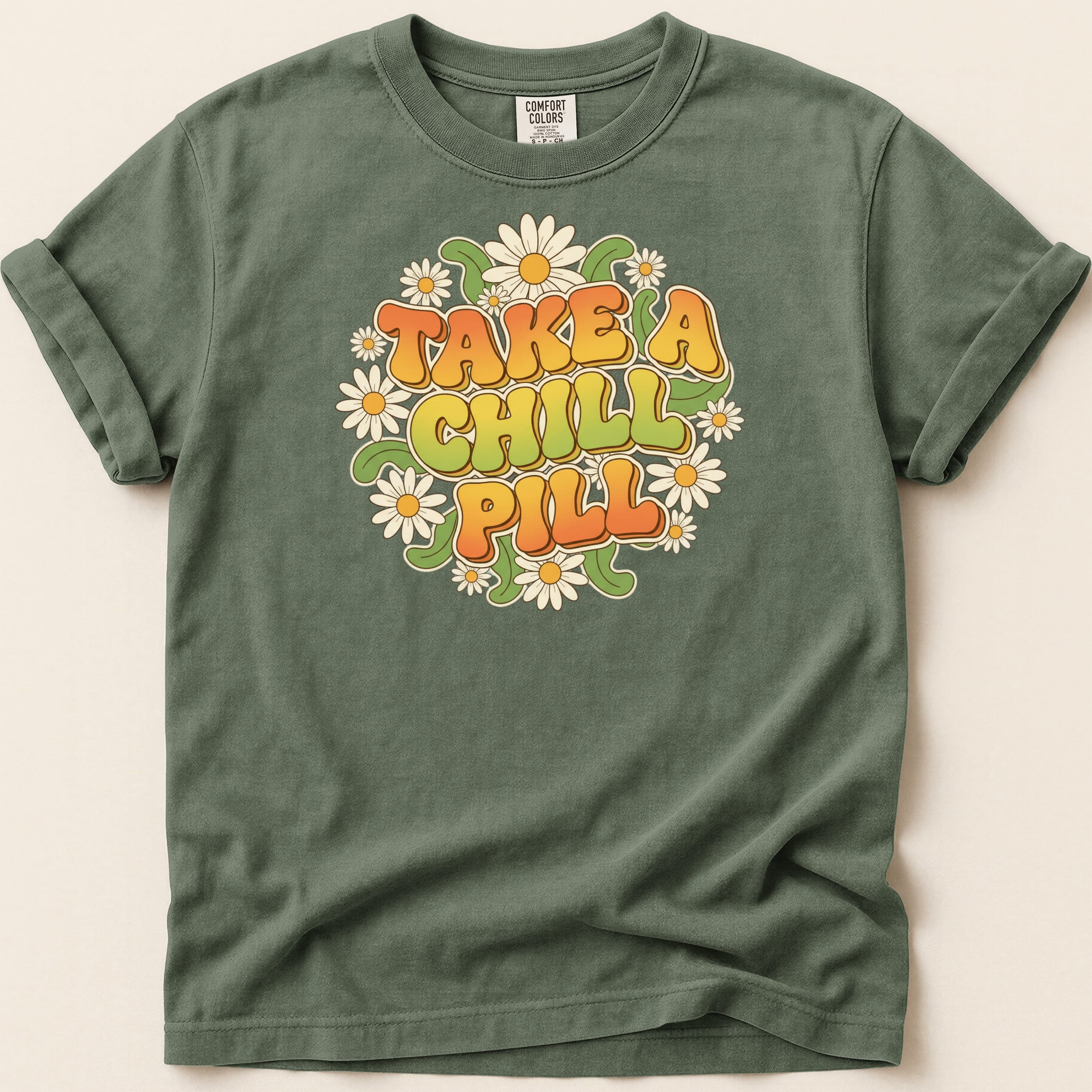 Green t-shirt with "TAKE A CHILL PILL" text and daisy graphic.