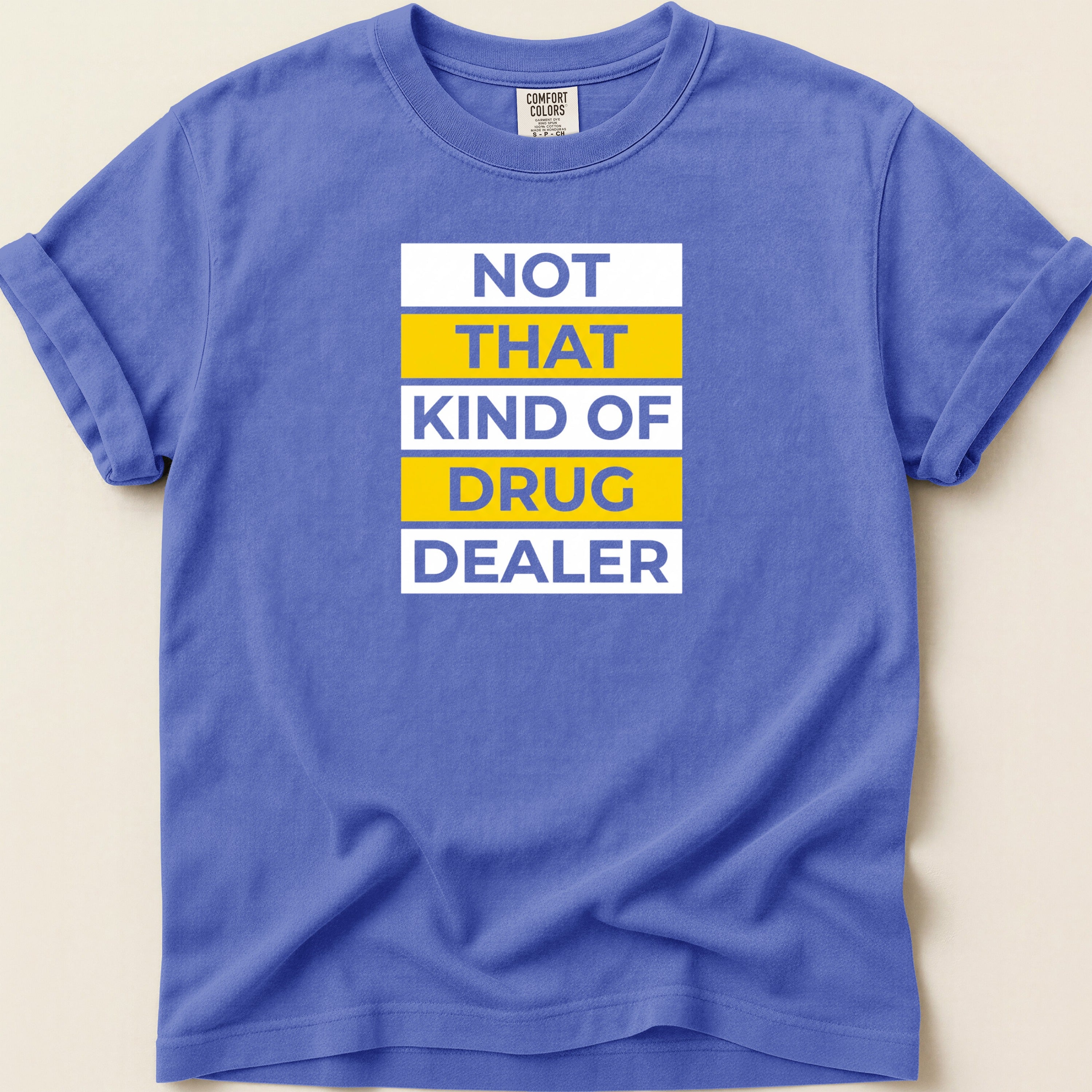 Purple t-shirt with "NOT THAT KIND OF DRUG DEALER" in yellow and white text.