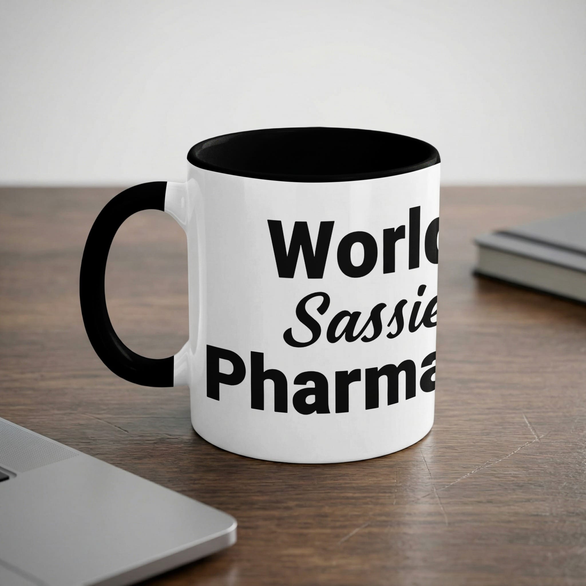 White mug with black rim and handle, reading "World's Sassiest Pharma..."