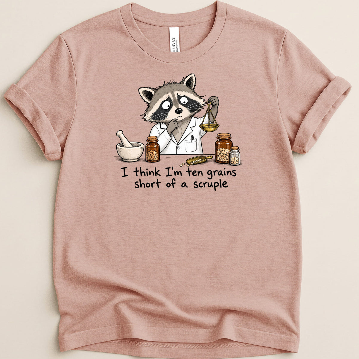 Illustration of raccoon in lab coat weighing grains with text "I think I'm ten grains short of a scruple."