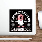 Cartoon capsule character with text "YEAH THAT'S STILL ON BACKORDER".