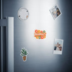 Sticker with "Pharmacy" in colorful flowers and small potted plant on refrigerator.