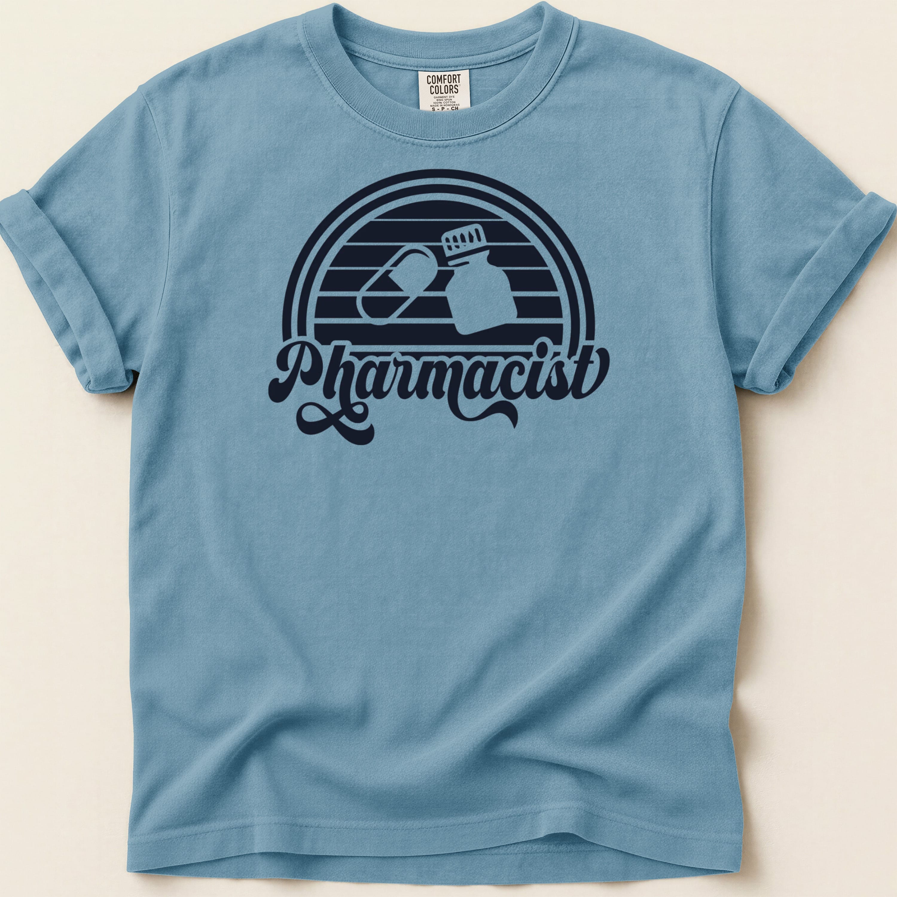 Blue t-shirt with "Pharmacist" text and pill graphic.
