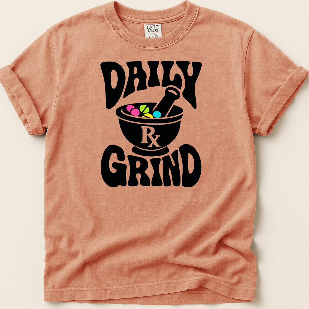 Peach t-shirt with black "DAILY RX GRIND" graphic featuring mortar and pestle.