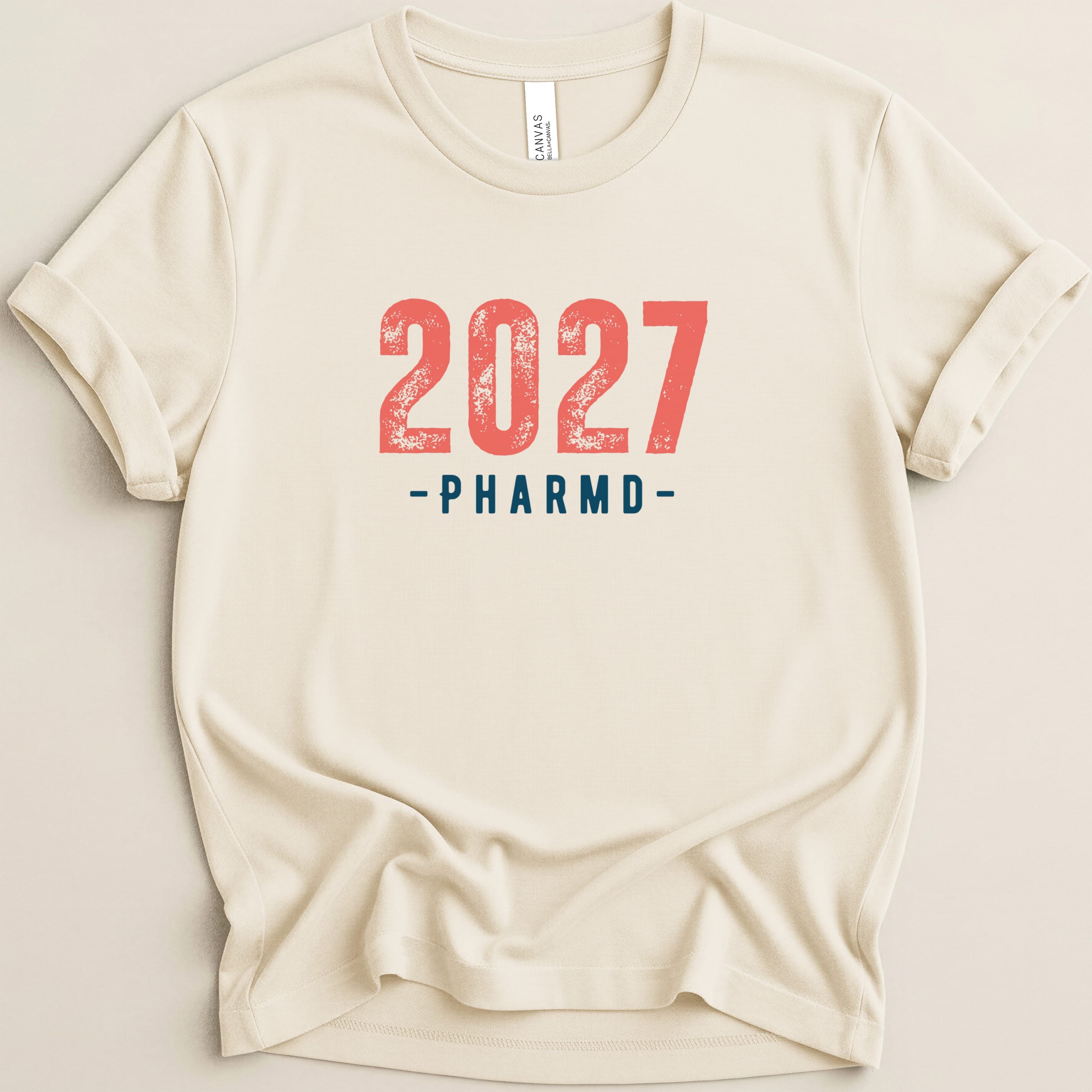 Cream t-shirt with "2027 PHARMD" text in red and blue.