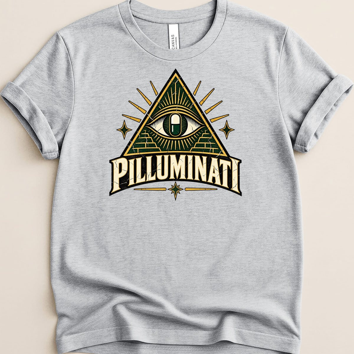 Gray t-shirt with a vintage-style graphic featuring an eye within a pyramid and the text "PILLUMINATI".