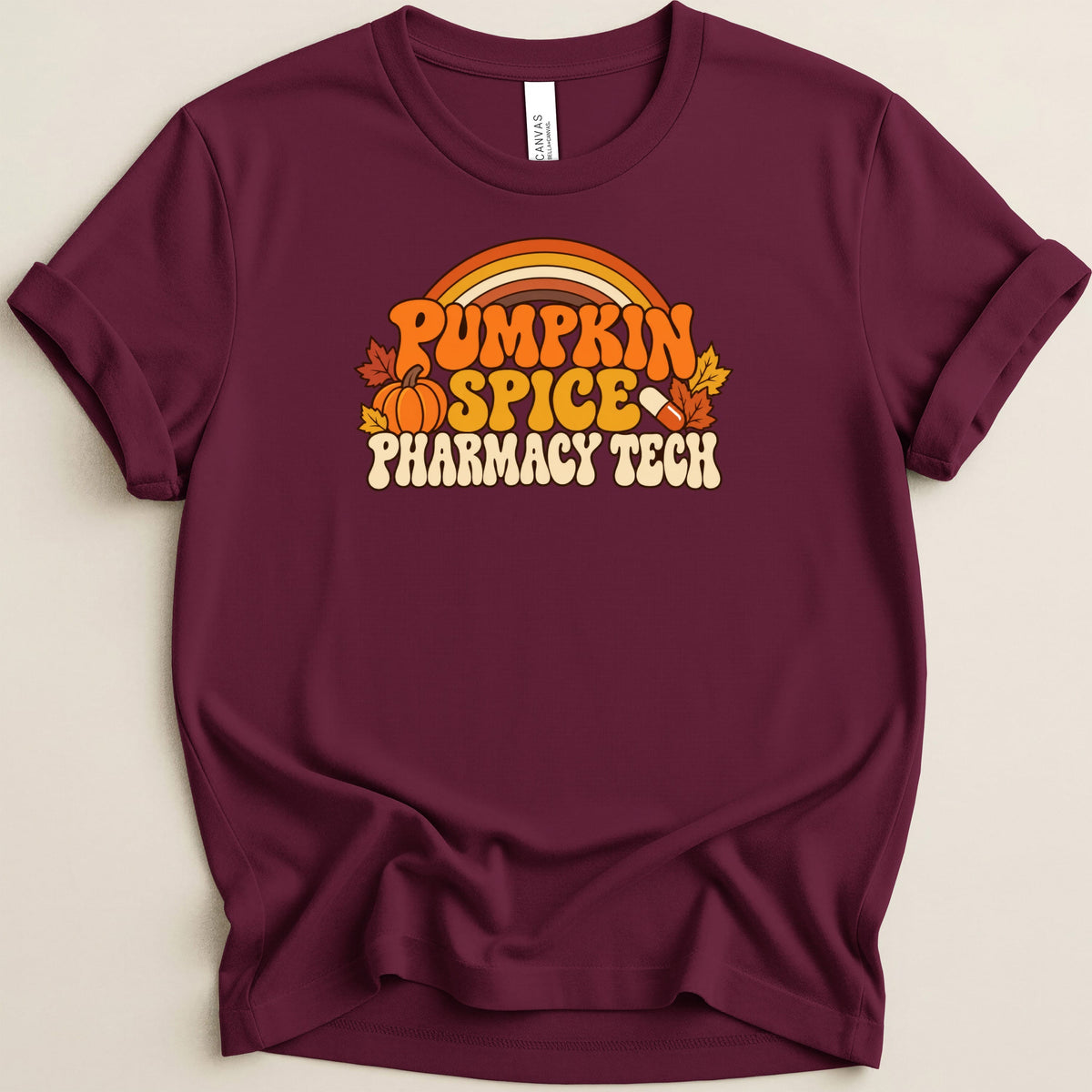 Maroon crewneck t-shirt featuring a retro fall graphic that reads Pumpkin Spice Pharmacy Tech.