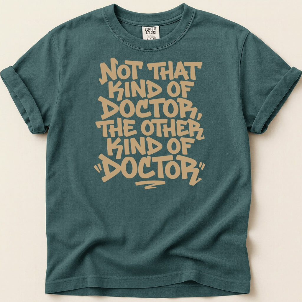 Teal t-shirt with "Not That Kind of Doctor, The Other Kind of Doctor" text.