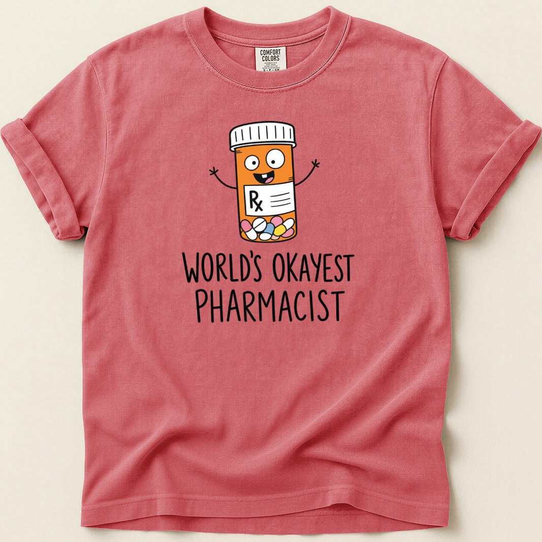Red t-shirt with a cartoon pill bottle and text "World's Okayest Pharmacist".