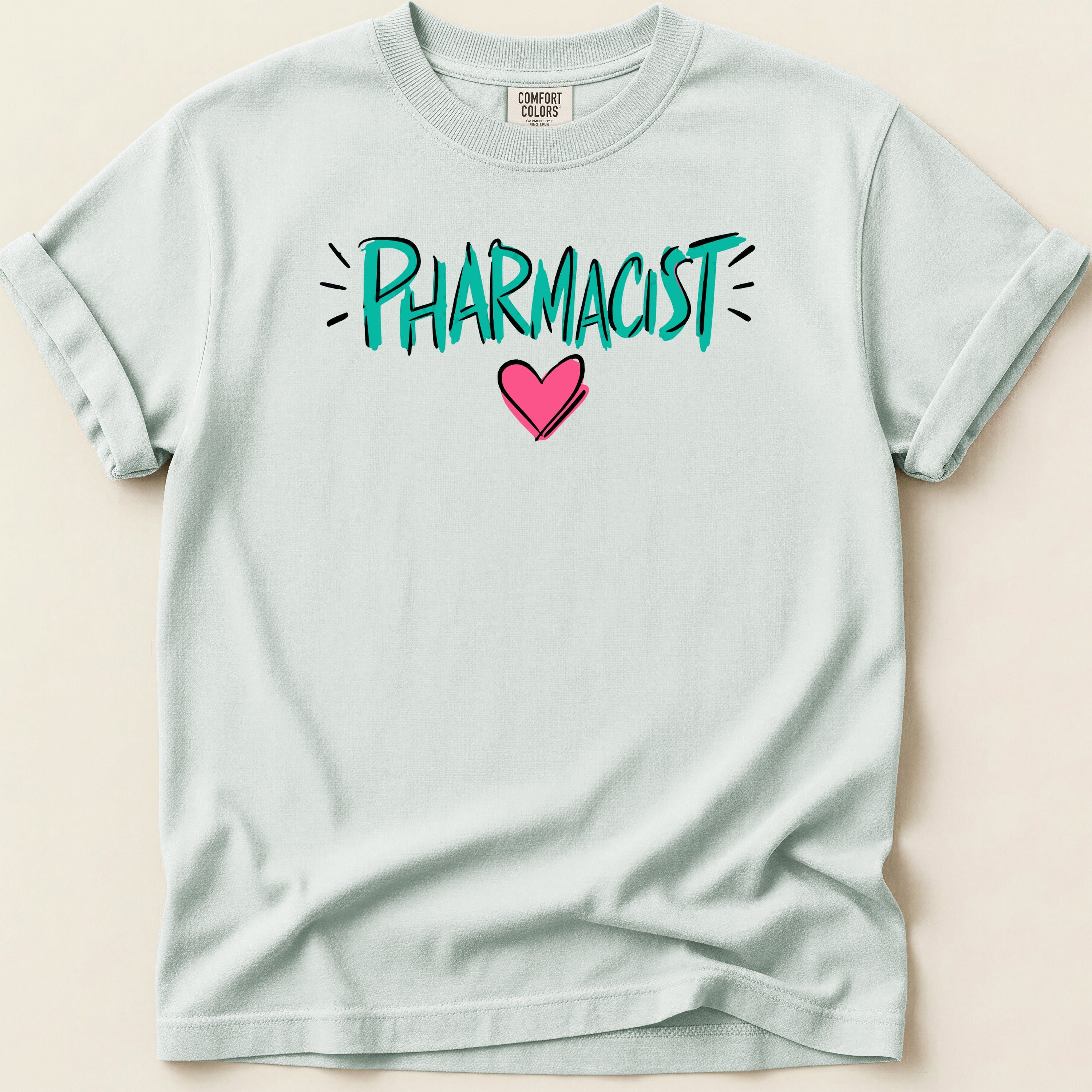 Light blue t-shirt with "PHARMACIST" in teal text and a pink heart.