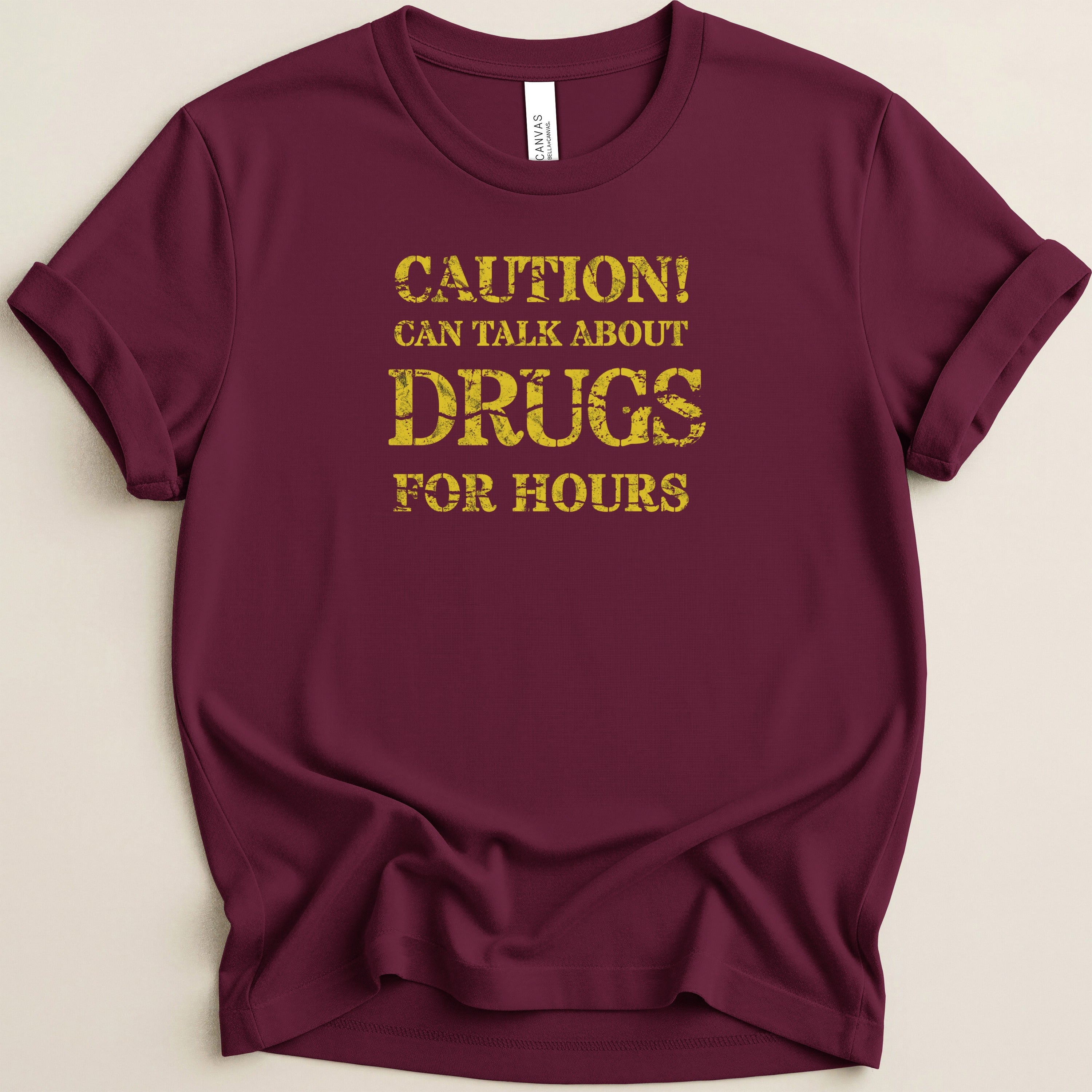 Maroon t-shirt with yellow distressed text: Caution! Can talk about drugs for hours.