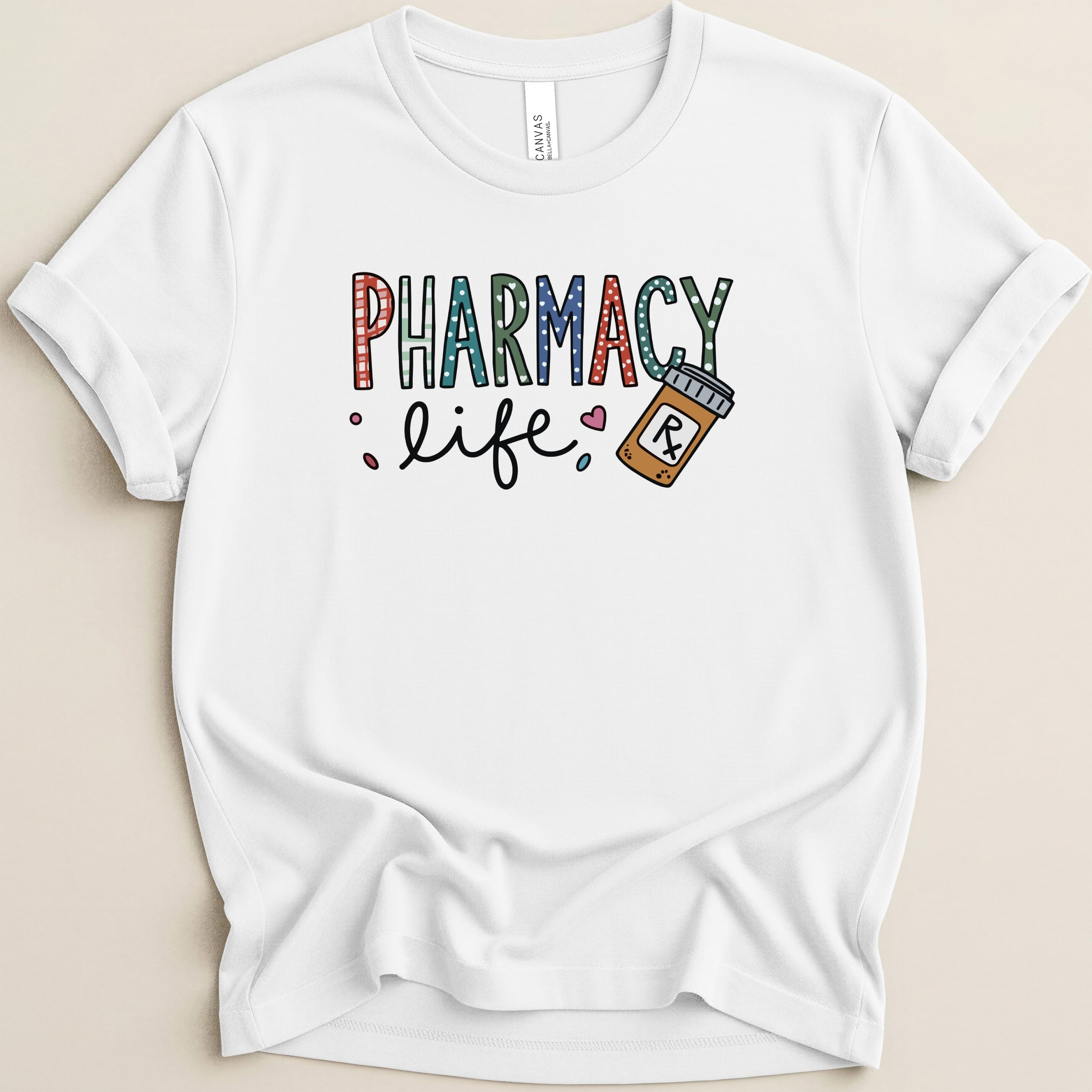 White t-shirt with colorful "Pharmacy Life" text and a pill bottle.